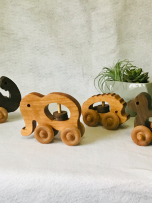 Handcrafted wooden toy rattles in Elephant, Hedgehog, Duck, and Turtle designs, perfect for engaging and entertaining little ones.