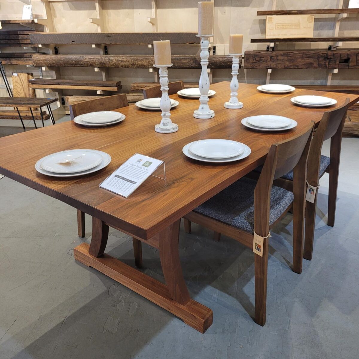 A dining table set with plates and candles, available at Fraser Wood Elements in Fredericksburg, VA.