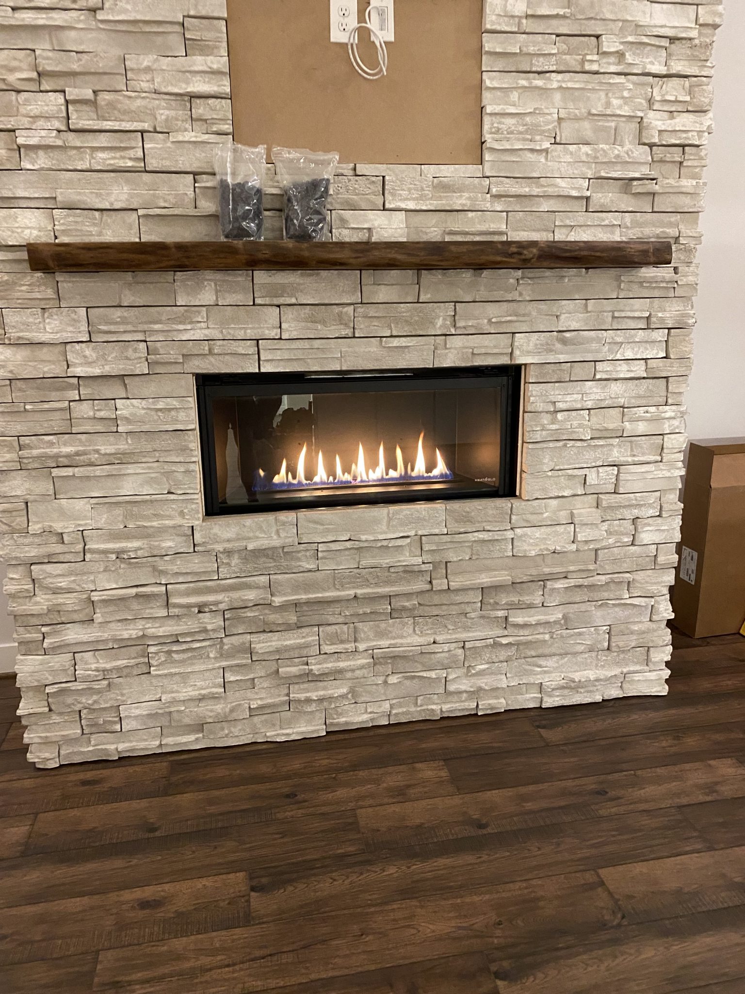 An example of a custom mantel shelf installed in a living room by Fraser Wood Elements in Fredericksburg, VA.