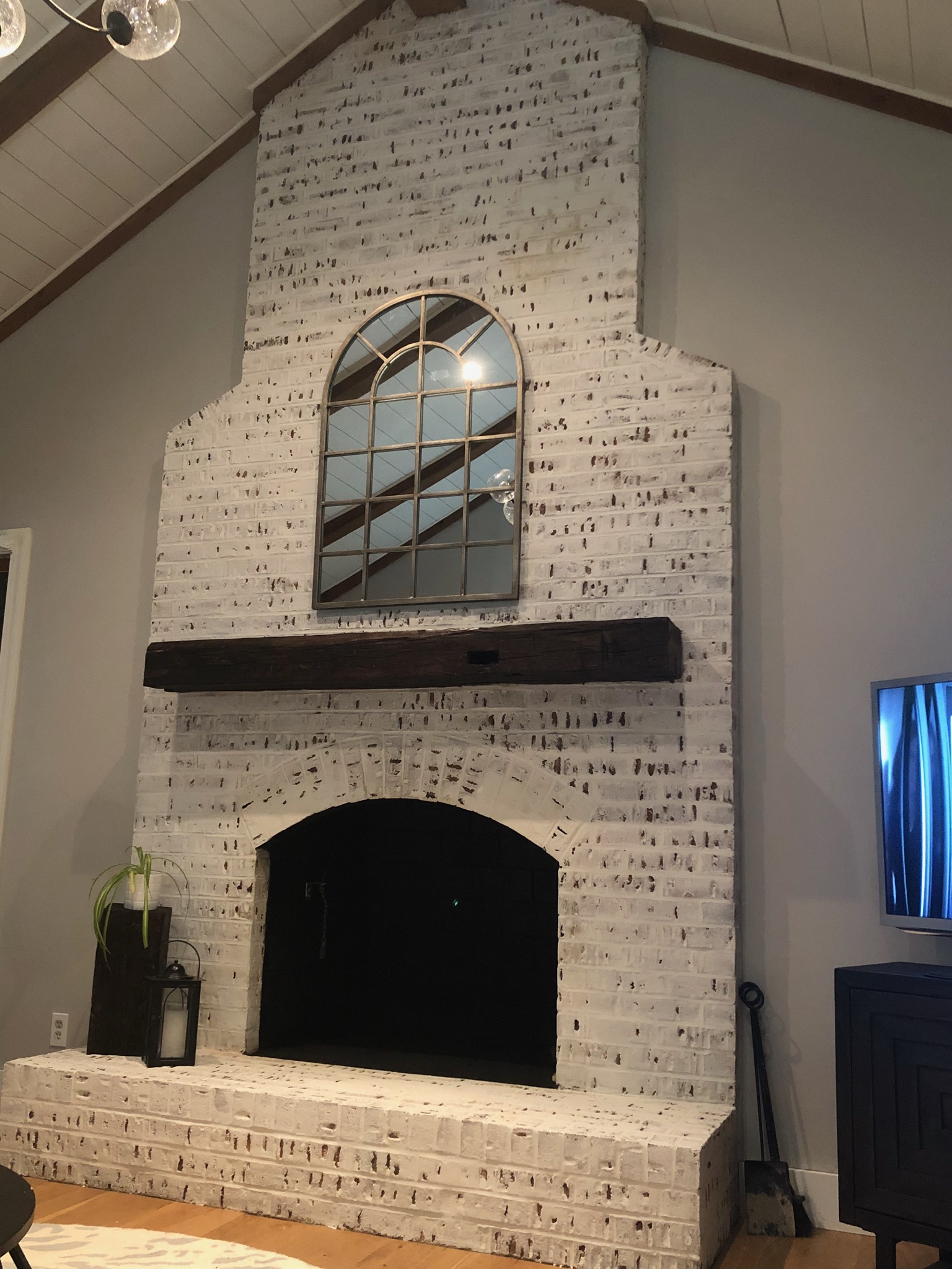 An example of a walnut mantel shelf installed in a living room by Fraser Wood Elements in Fredericksburg, VA.