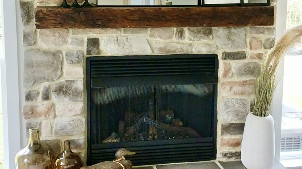 An example of a custom mantel installed in a living room by Fraser Wood Elements in Fredericksburg, VA.